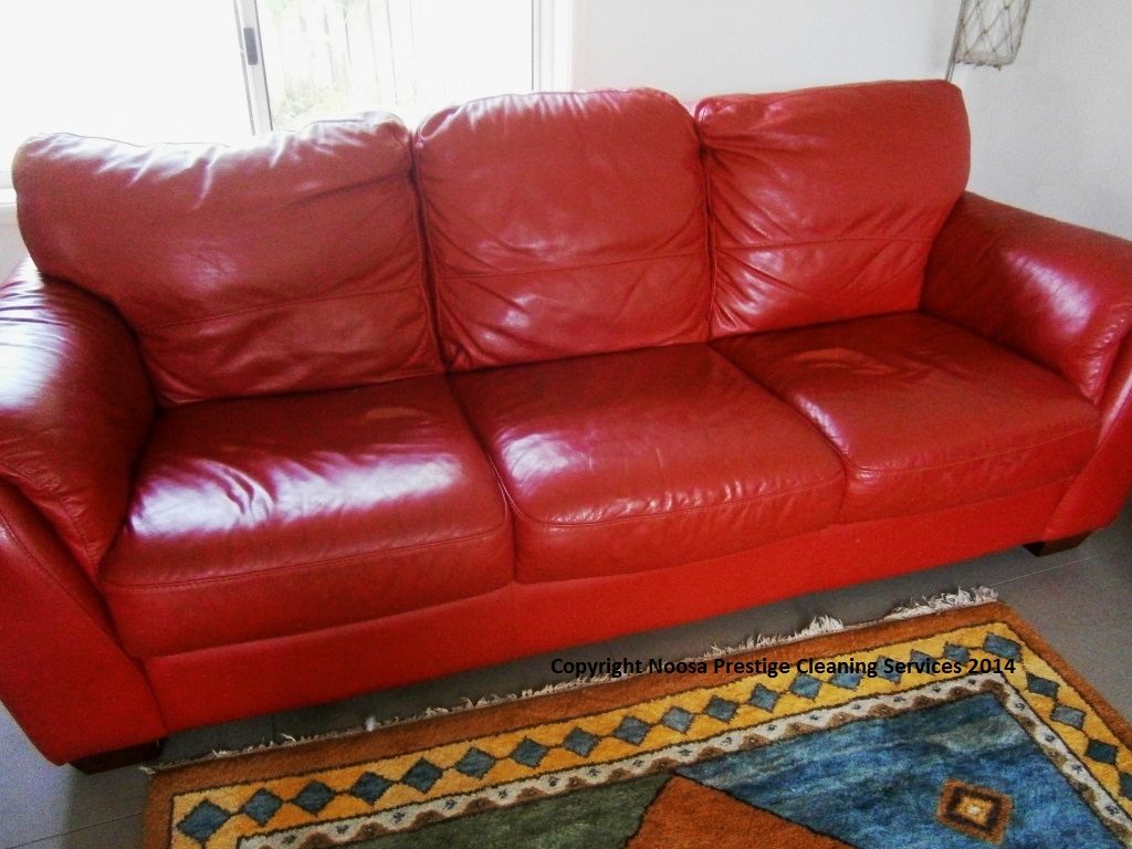 Red leather lounge before professional cleaning